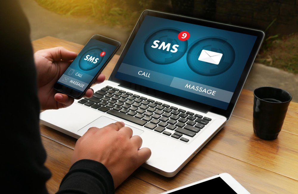 Person using laptop and smartphone