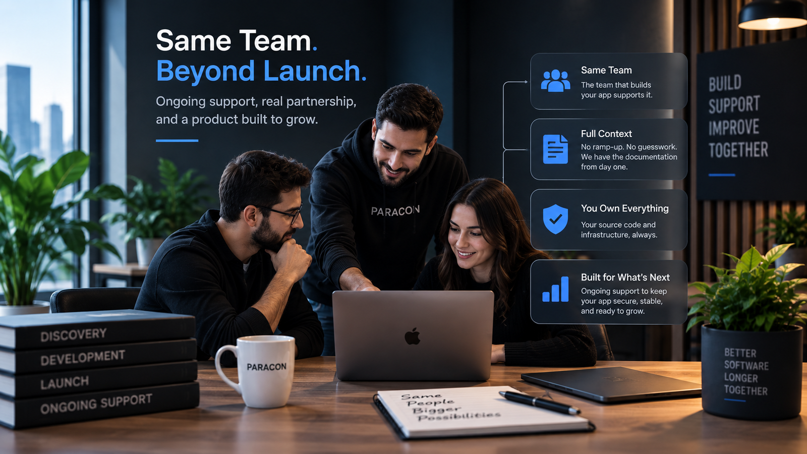 Paracon development team collaborating on a laptop to provide ongoing app maintenance, technical support, and long-term software improvements.